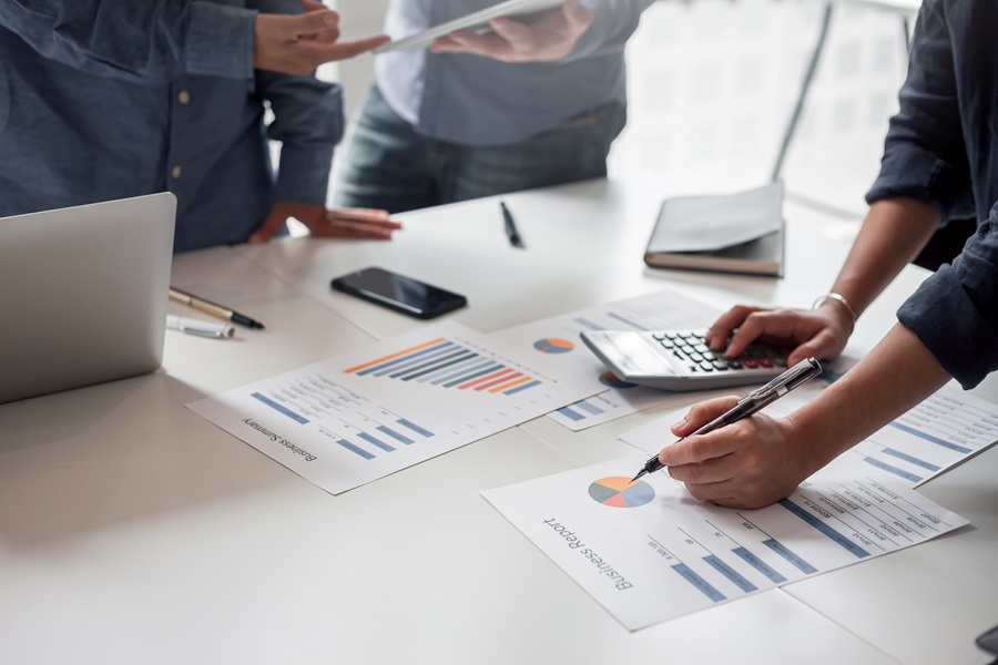 Business Development Close up of people working on plans at a table